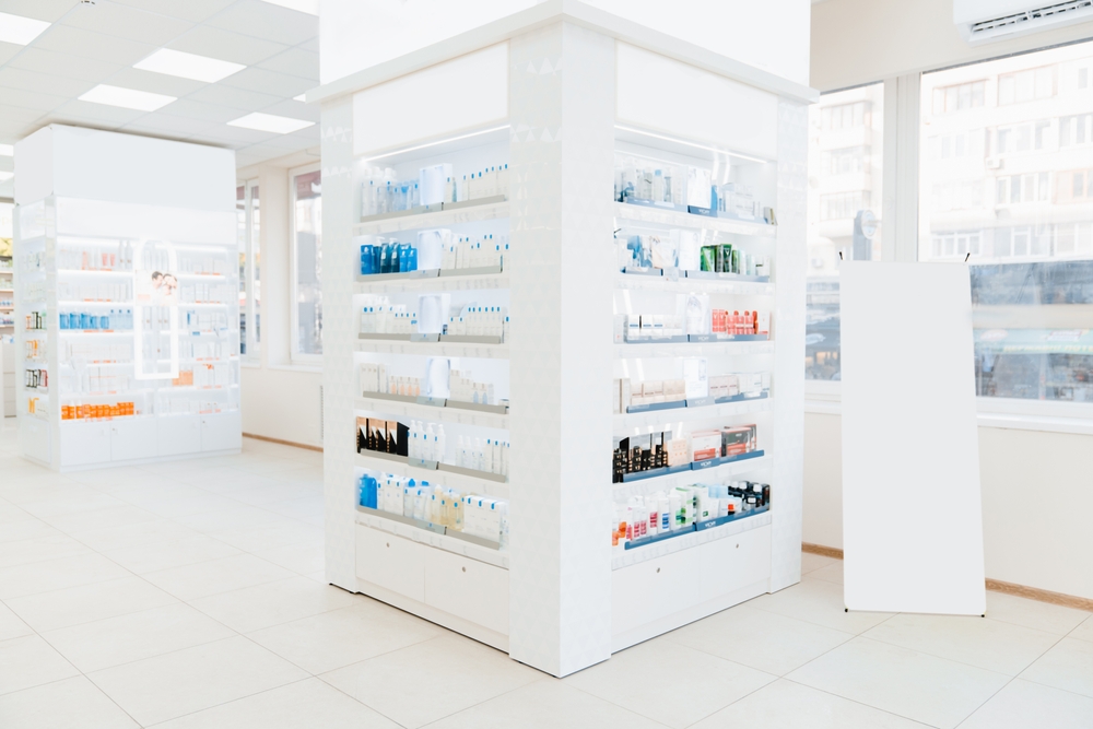 Empty drugstore chemist`s shop pharmacy without staff clients customers visitors with remedies, pills, medicines, goods, painkillers, jars on shelves.